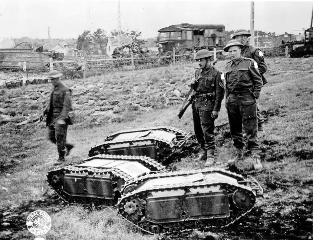 British soldiers with captured German Goliath tracked mines (Public Domain)