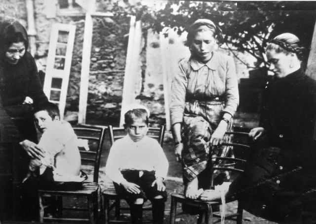 A Bulgarian mother showing a bullet wound her child recieved during the Greek occupation of Petrich (left). Two other women show bullet wounds on their feet.