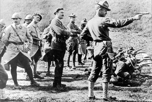 US Marines, recently arrived in France during World War I, demonstrate their marksmanship as curious French soldiers stand by to watch,