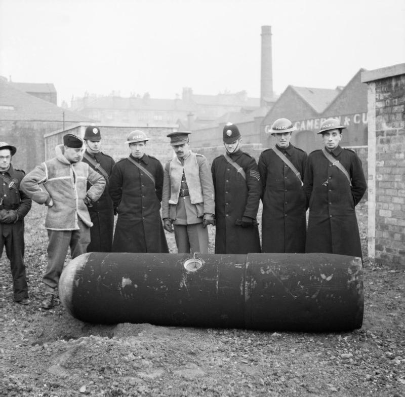 Soldiers standing around a diffused bomb during Clydebank Blitz.
