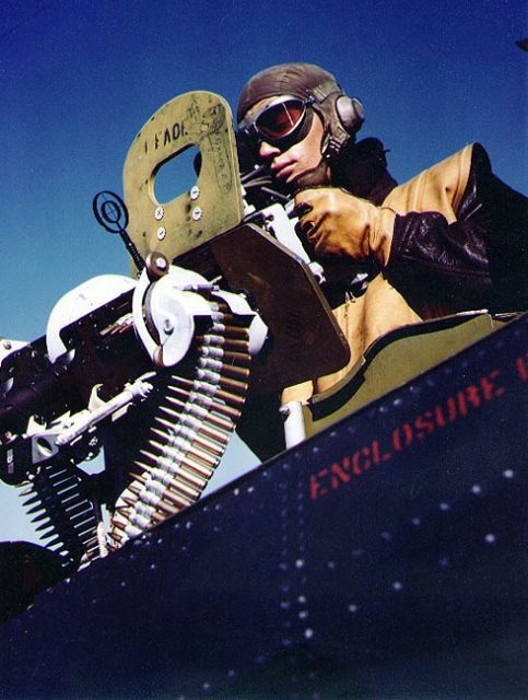 An SBD gunner aims his twin .30 caliber machine guns aboard USS Independence.