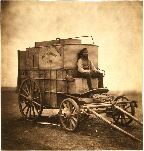 Roger Fenton's assistant sitting on his photographic van.