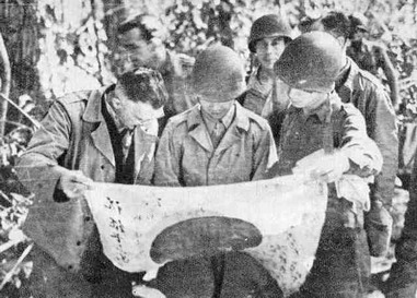 GENERAL STILWELL ON AN INSPECTION TOUR STUDYING A RECENTLY CAPTURED Japanese FLAG