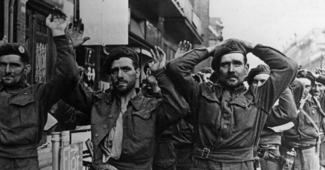 British prisoners at Arnhem Bridge. They are unshaven after four days of fighting – water was scarce during the battle. Photo Credit.