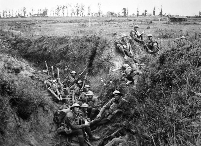 Members of the Australian 6th Battalian resting in a trench during the Battle of Amiens. Wikimedia Commons / Public Domain. 