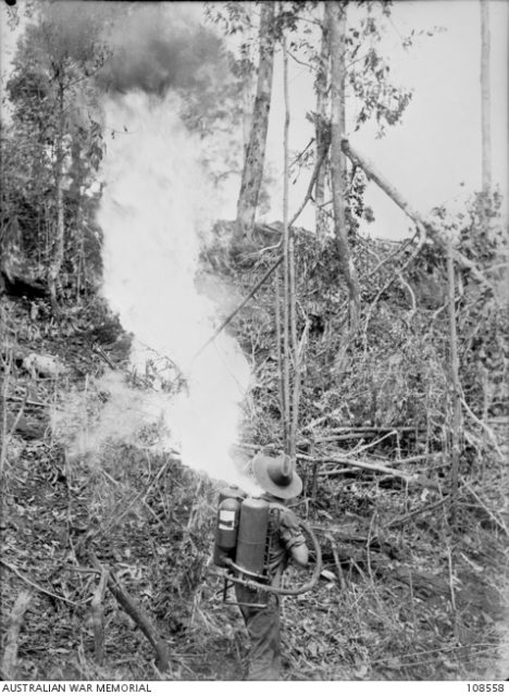 Seargant K. Wilde, Pioneer Platoon, 2/23 Infantry Battalion, using a flamethrower on the entrance to a Japanese bunker during cleaning up uperations on Margy Feature. Tarakan Island, 1 June 1945 [© AWM (108558)].