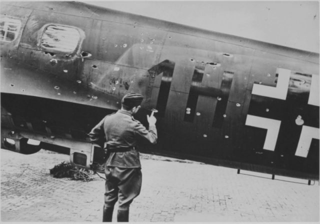 German Officer examines the bullet holes on the fuselage of Heinkel He 111. The damage was caused by 7,69mm machine guns of British aircraft. [Via]