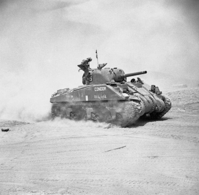 British Sherman tank advancing near Catania, Sicily. 4 August 1943. [© IWM (NA 5522)]