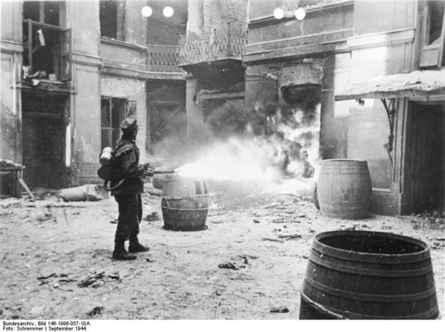 German soldier with flamethrower during Warsaw Uprising. Germans were "cleaning" in that way all buildings, street by street, in order to prevent insurgents for using this places again. 11 September 1944[Bundesarchiv, Bild 146-1996-057-10A / Schremmer / CC-BY-SA 3.0].