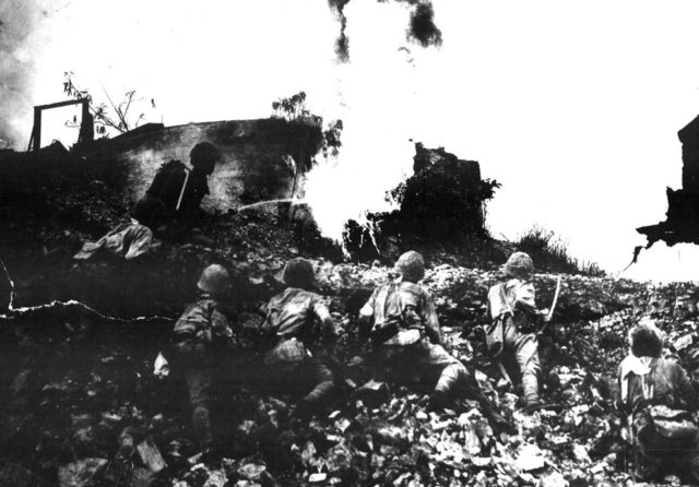 Japanese troops clearing an American position with flamethrower, Corregidor, Philippine Islands, May 1942 [United States National Archives].