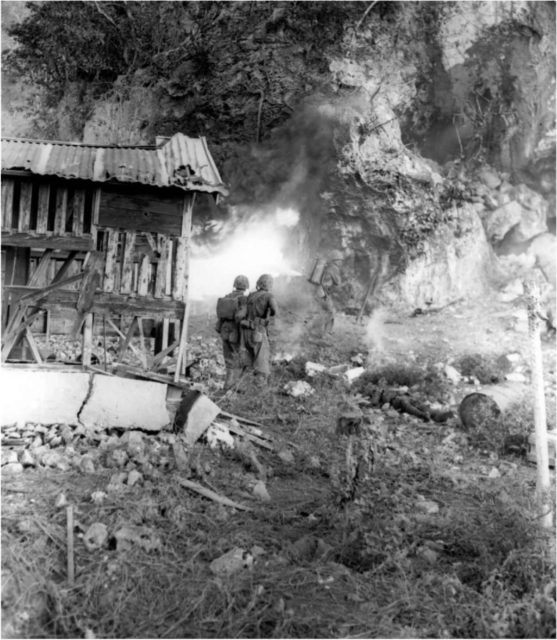 The two men in the center foreground are watching to intercept any of the enemy who might try to escape [Via].