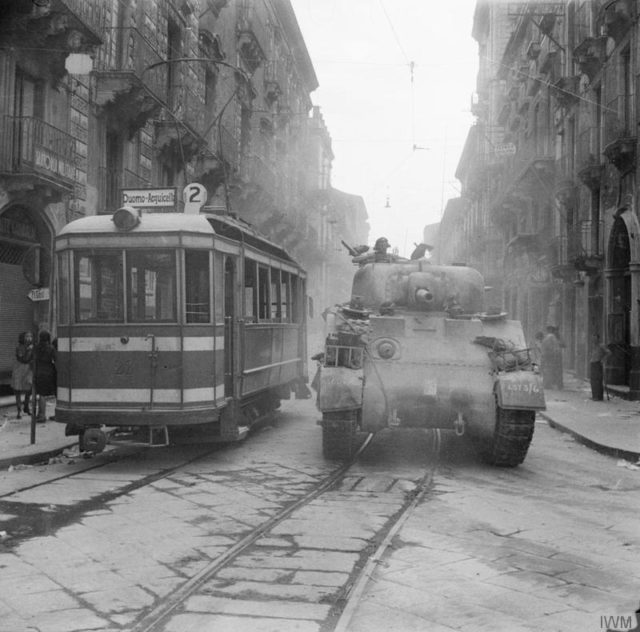 A sherman tank passes a tram in the Via Garibaldi during the entry into Catania. 5 August 1943. [© IWM (NA 5558)]