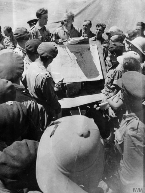 Royal Air Force glider pilots and pilots of towing aircraft are briefed before the airborne invasion. [© IWM (CNA 1658)]