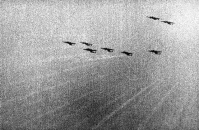 A still from camera-gun film taken from a Supermarine Spitfire Mark I of No. 609 Squadron RAF, flown by Flying Officer Tadeusz "Novi" Nowierski (formerly Polish Air Force) as he closes in on a formation of Dornier Do 17Zs of KG3 south-west of London at approximately 5.45 pm on 7 September 1940, the first day of the Blitz. Tracer bullets from the intercepting Spitfires can be seen travelling towards the enemy aircraft which were heading back to their base after bombing East London and the docks. [© IWM (CH 1820)]