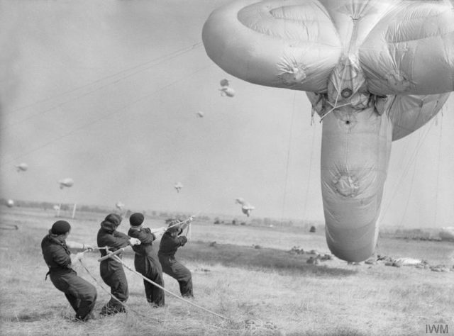 The Women's Auxiliary Air Force (WAAF): Aircraftwomen learning how to handle a barrage balloon at the training station at Cardington. [© IWM (CH 7346)]