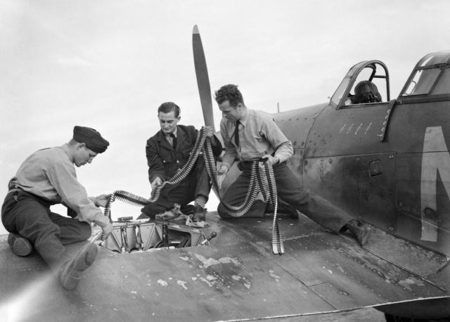 Armourers replenish the ammunition in a Hawker Hurricane Mk I of No. 310 (Czechoslovak) Squadron RAF at Duxford, Cambridgeshire, 7 September 1940. [© IWM (CH 1297)]