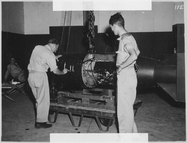 Project Alberta's Commander Francis Birch (left) assembles the Little Boy bomb while physicist Norman Ramsey watches. Wikipedia / Public Domain