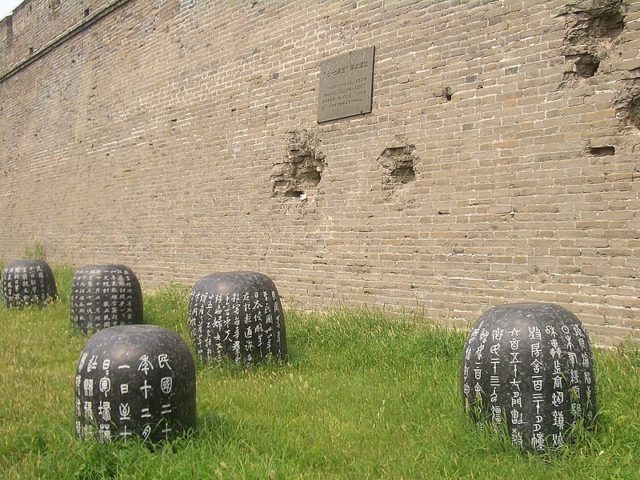 Memorial plaque on the south wall of Wanping Castle. The stone drums tell the story of China's resistance against Japanese occupation Image Source: Vmenkov CC BY-SA 3.0