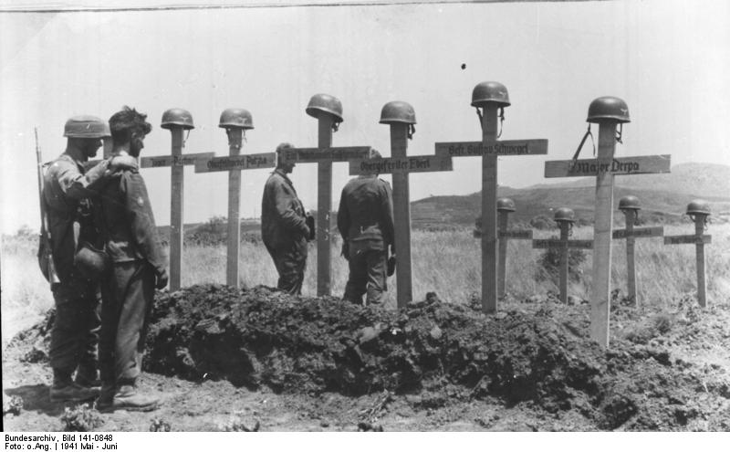 German soldiers pause before the graves of their fallen comrades. By Bundesarchiv - CC BY-SA 3.0 de
