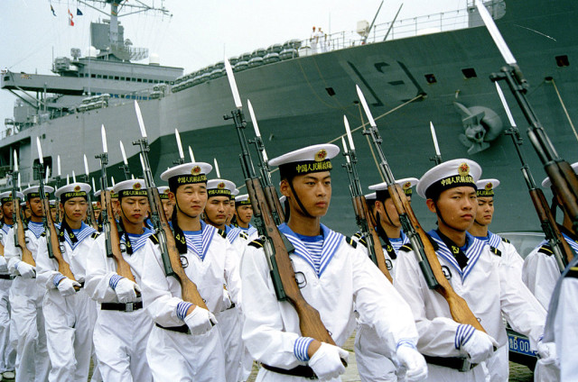 Chinese sailors at the Qingdao, North Sea Fleet headquarters parading with in 2000 for a visiting U.S. Navy delegation. By Jiang at en.wikipedia - Public Domain.