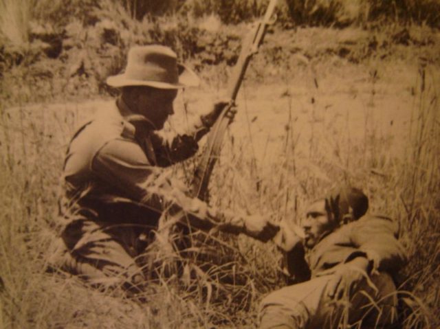 ANZAC soldier giving a wounded Turk a drink.