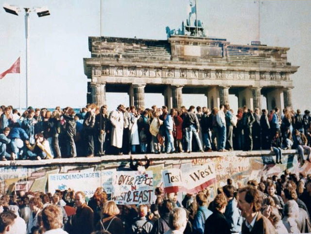 The fall of the Berlin Wall in 1989. Wikimedia Commons / unknown / Lear 21 at English Wikipedia.