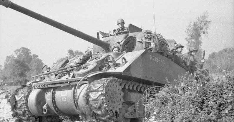 Sherman Firefly carrying infantry during Operation 'Goodwood', 18 July 1944.