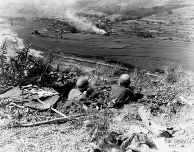 Troops of the U.S. 27th Infantry await North Korean attacks across the Naktong River from positions on the Pusan Perimeter, September 4, 1950.