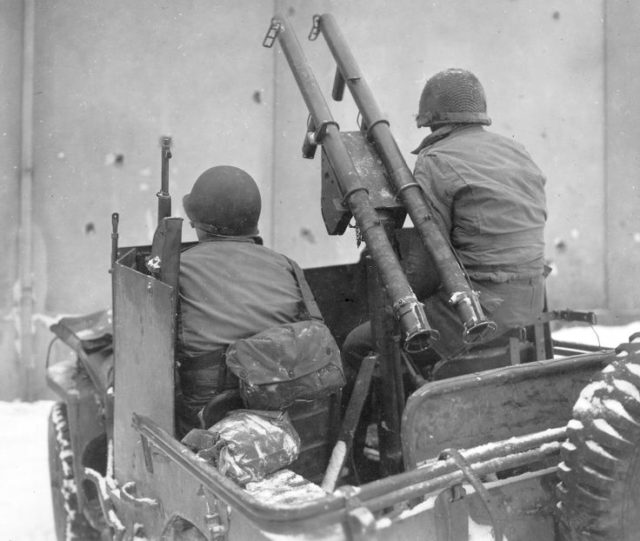 The photo above shows the Twin M1A1 Bazookas mounted on an “Anti-Tank” Jeep. It was the light-weight yet very effective Bazooka that helped save the Chateau Rolle from possibly a total destruction at the moment it was attacked by seven German tanks. As soon as the Germans had found out about the role of the Chateau as a Command Post, Weapons Depot, Hospital and Radio Communications center for the 101st Airborne Division/ 502nd PIR, they had good reasons to launch an assault from the little village Champs on this Chateau.