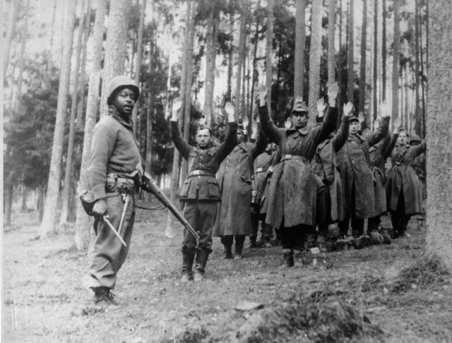 African-American soldier with the 12th Division capturing German POWs in April 1945 Image Source: