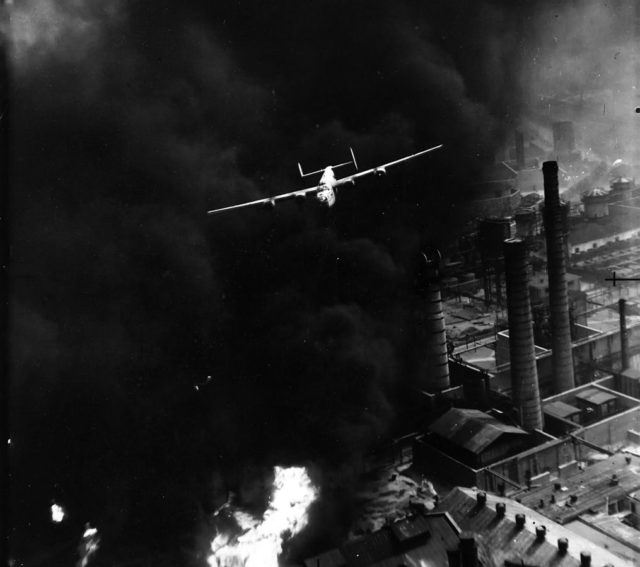 One of the most famous images of World War II shows "The Sandman", piloted by Robert Sternfels, as it emerges from a pall of smoke during the Operation Tidal Wave [Wikipedia / Public Domain]