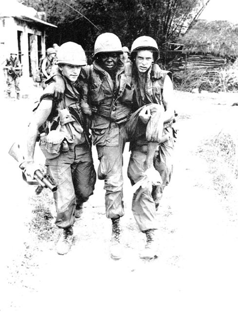 Pfc. Mauro, Pfc Carter, and SP4 Widmer (Carter shot himself in the foot during the My Lai Massacre). By Ronald L. Haeberle - "Report of the Department of Army review of the preliminary investigations into the My Lai incident. Volume III, Exhibits, Book 6 - Photographs, 14 March 1970". From the Library of Congress, Military Legal Resources.[1], Public Domain, https://commons.wikimedia.org/w/index.php?curid=3770753