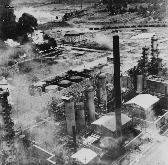 Oil storage tanks at the Columbia Aquila refinery burning after the raid of B-24 Liberator bombers of the United States Army Air Force. Some of the structures have been camouflaged. Ploesti, Romania. August 1, 1943 [U.S. Air Force / Public Domain]