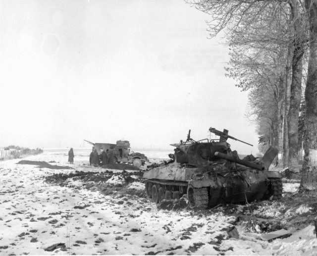 Above a dramatic picture of a destroyed M18 Hellcat and M3A1 Halftrack in the backdrop from 705th Tank Destroyer Battalion which supported the 101st Airborne at Bastogne. Allegedly, throughout the siege of Bastogne (20-27 Dec. 1944), the Americans shot around 40 German tanks and lost only six of their own. 