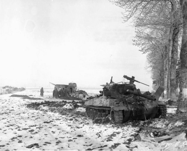 Above a dramatic picture of a destroyed M18 Hellcat and M3A1 Halftrack in the backdrop from 705th Tank Destroyer Battalion which supported the 101st Airborne at Bastogne. Allegedly, throughout the siege of Bastogne (20-27 Dec. 1944), the Americans shot around 40 German tanks and lost only six of their own.