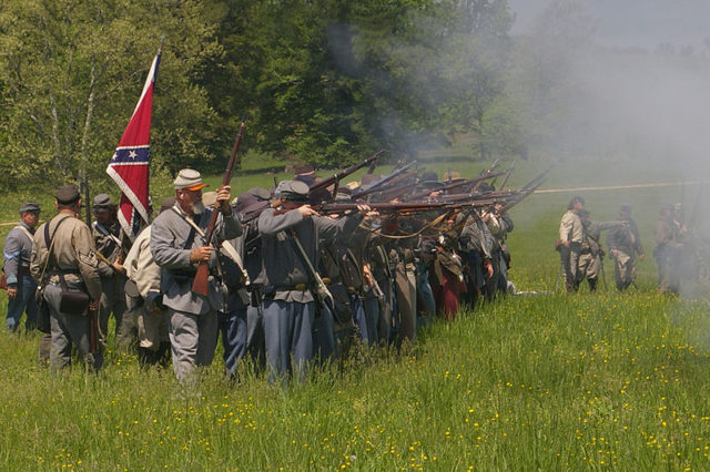 Confederate reenactors fire their rifles during a reenactment in 2008. Wikimedia Commons / MamaGeek / CC BY-SA 3.0