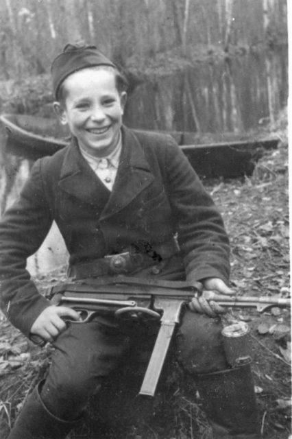 15 years old Misha Petrov with captured German MP-38 and Soviet grenade RGD-33 in his boot [Via]