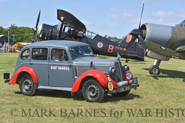 This scene almost looks authentic, but odd bits give it away, including the snout of the post war Hunting Percival Provost. The car is a 1938 Hillman Minx wearing RAF bomb disposal livery.