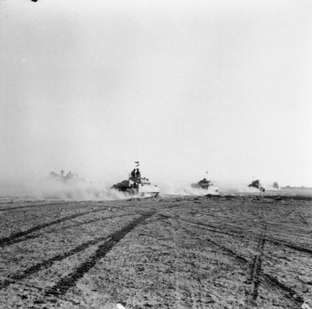 British tanks advance to engage German armour after infantry had opened gaps in the Axis minefield at El Alamein, 24 October 1942 - Wikipedia / Public Domain