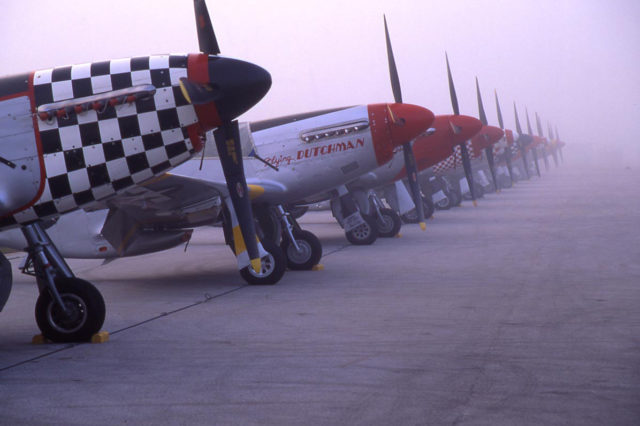 Parked P-51s in the early morning mist - Image by Tom Smith / The Gathering of Mustangs and Legends 