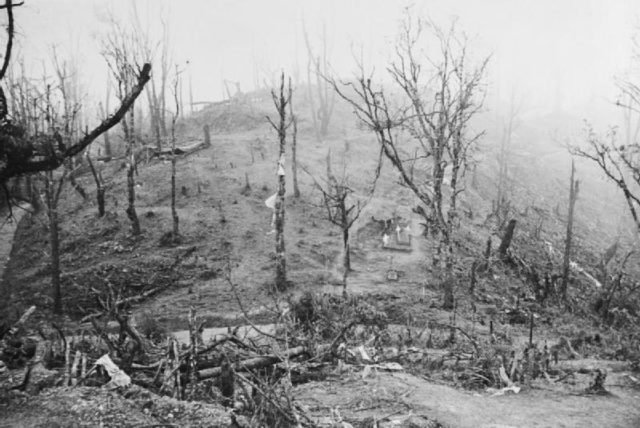 Garrison Hill during the battle, the strands of fabric hanging from trees are from supply parachutes. Source: Wiki/ public domain.