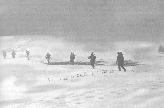 American troops marching away from Krinkelt, after it finally fell to the Germans. They would retreat to positions along the Elsenborn ridge, and from there would continue fighting the German onslaught. Image Source: Wikimedia Commons/ public domain.