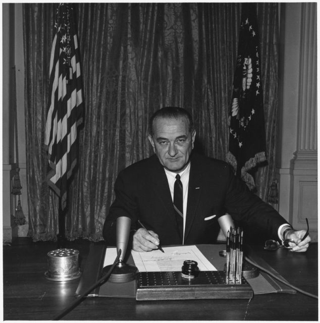 President Lyndon B. Johnson signing the Gulf of Tonkin Resolution on August 19, 1964 Image Source: Wikipedia / Public Domain