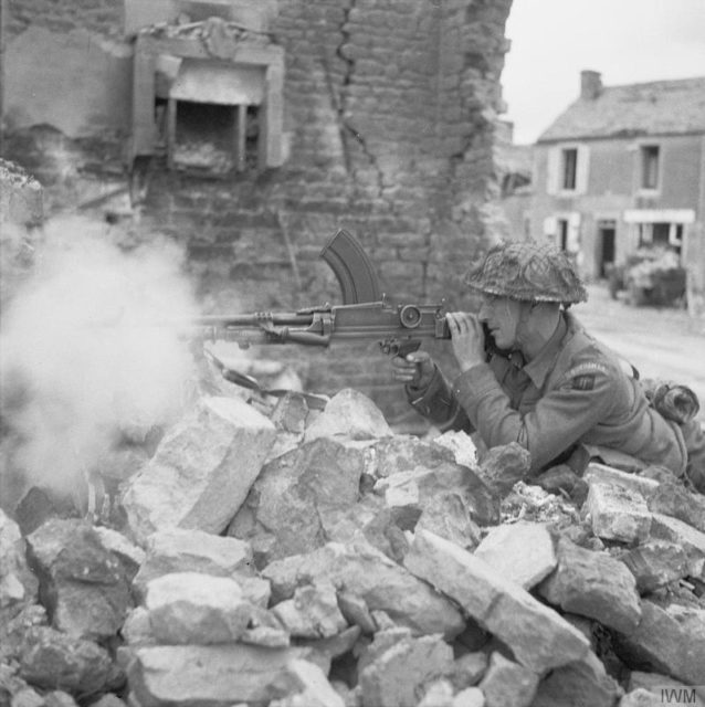 Private W Wheatley of 'A' Company, 6th Battalion Durham Light Infantry, 50th Division, fires his Bren gun from a ruined house in Douet, near Bayeux, 11 June 1944. By No 5 Army Film & Photographic Unit, Laing (Sgt) - http://media.iwm.org.uk/iwm/mediaLib//38/media-38375/large.jpgThis is photograph B 5382 from the collections of the Imperial War Museums., Public Domain, https://commons.wikimedia.org/w/index.php?curid=39792632