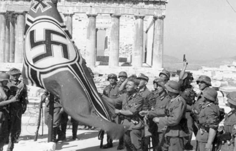 German soldiers raising the German War Flag over the Acropolis. <a href=https://commons.wikimedia.org/wiki/Category:Images_from_the_German_Federal_Archive>Photo Credit</a>