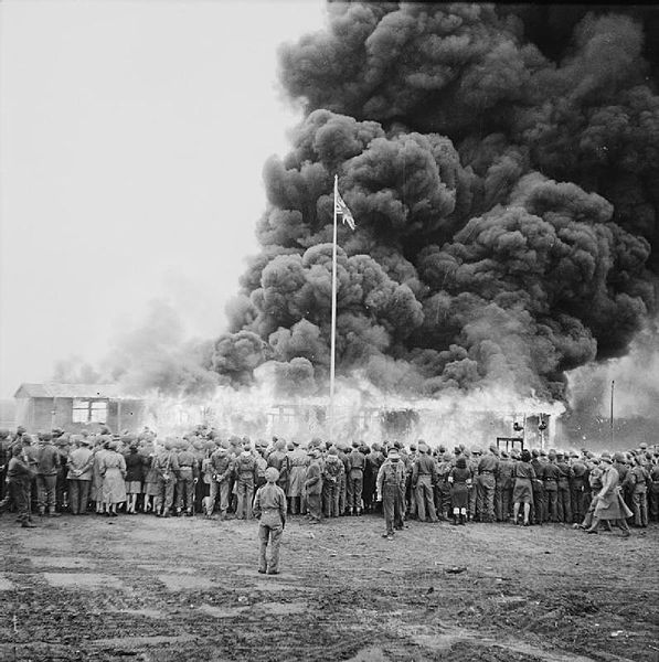 Crowds watching the last building of Bergen-Belsen being burned. Wikimedia Commons / Public Domain.