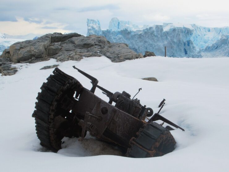 Rusty military vehicle half-buried in the snow