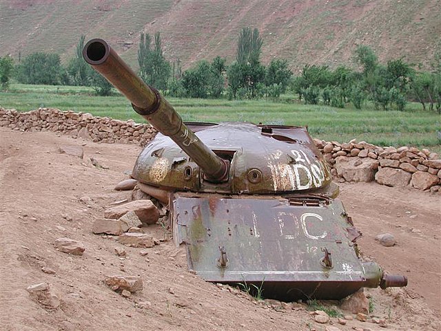 Rusty T-62 tank buried in the sand