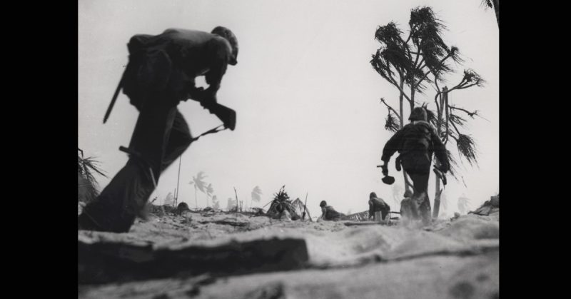 Marines at Tarawa. Source: By USMC Archives from Quantico, USA - Marines Under Fire, Tarawa, November 1943, CC BY 2.0, https://commons.wikimedia.org/w/index.php?curid=42679035