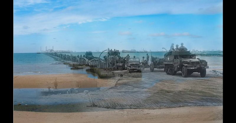 US Army vehicles come ashore on one of the floating causeways of the Mulberry artificial harbour off Omaha Beach, Normandy, 16 Jun 1944 - 2015